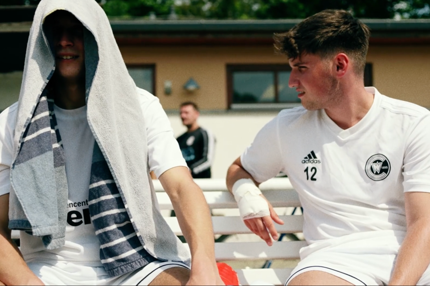 Player lacing Adidas boots on the sideline during Back to Club film shoot in Berlin